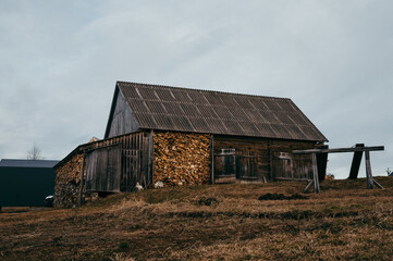 old wooden house stands against the gray sky