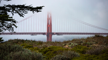 panorama of the golden gate bridge in san francisco during foggy weather; the famous red bridge...