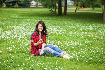 Young beautiful brunette girl in summer street