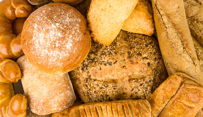 Background of different types of bread and sweet pastries.