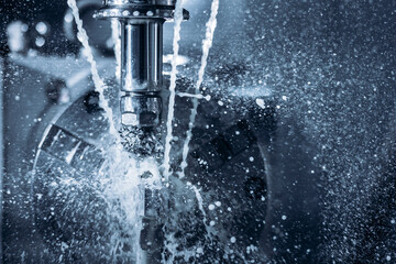 Fototapeta na wymiar Coseup Working CNC turning cutting metal Industry machine iron tools with splash water