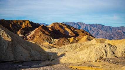 panorama of the mountains in golden canyon during the spring sunrise; the famous coloured mountains which can be seen from zabriskie point; hiking in golden canyon in death valley national park