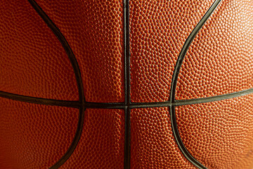 Fragment of a basketball in the sunlight close-up, macro