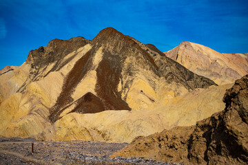 panorama of the mountains in golden canyon during the spring sunrise; the famous coloured mountains which can be seen from zabriskie point; hiking in golden canyon in death valley national park