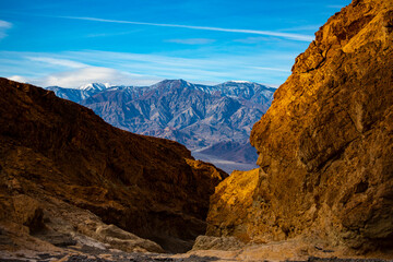 Obraz premium panorama of the mountains in golden canyon during the spring sunrise; the famous coloured mountains which can be seen from zabriskie point; hiking in golden canyon in death valley national park