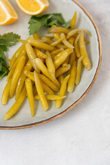 jalapeno on a plate with herbs and lemon on a gray stone background