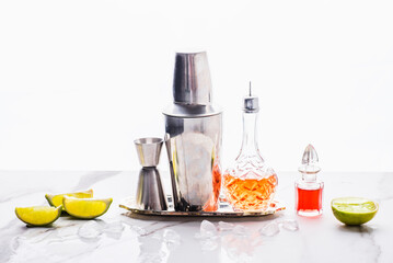 Barmans tools and props, aromatichand made essences and aromatic tinctures or  extract  on the white background, ice and lime. Trends of cocktails