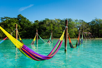 Woman on hammock in Bacalar lagoon Mexico - 574406334
