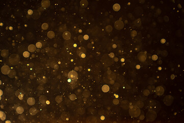 Organic bokeh dust particles floating on light beam on black background. Glittering sparkling...