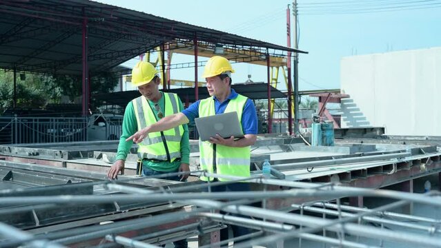 Construction supervisor monitors progress and supervises important construction works in the construction area.