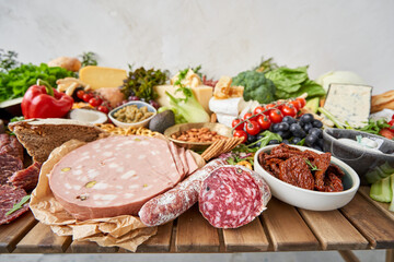 Salami and Parma sausage close-up. Table full of mediterranean appetizers, tapas or antipasto....