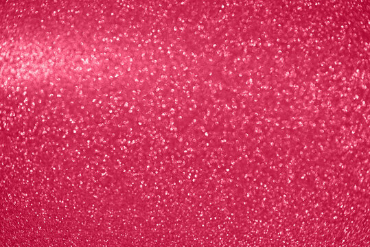 Abstract festive shiny background, defocused. Image toned in color of the year 2023 Viva magenta.
