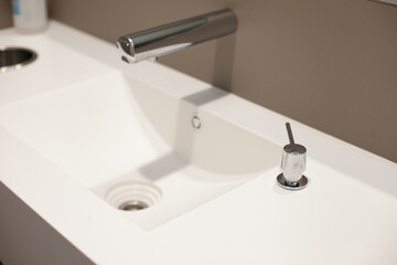 minimal faucet and sink in modern office public bathroom