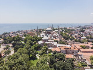 Fototapeta na wymiar Top view of the Hagia Sophia in the old city of Istanbul against the backdrop of the sea, on a warm summer day