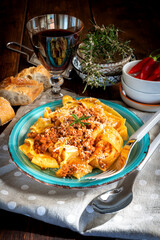 Homemade pappardelle with meat sauce on the plate