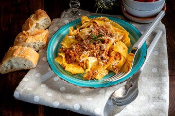 Homemade pappardelle with meat sauce on the plate