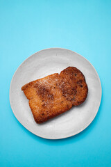 Baked or fried bread with sugar and cinnamon. Dessert called Rabanada.