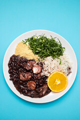 black beans stew with sausages on a white dish
