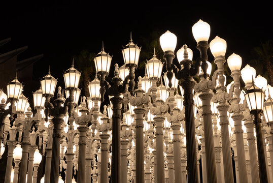 Los Angeles, United States - November 17, 2022: A picture of Urban Light, a public art designed by Chris Burden and unveiled in 2008, next to the Los Angeles County Museum of Art, at night.
