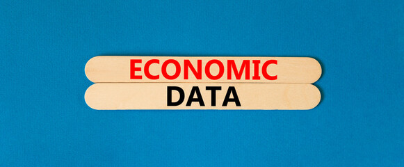 Economic data symbol. Concept words Economic data on wooden sticks. Beautiful blue table blue background. Business economic data concept. Copy space.