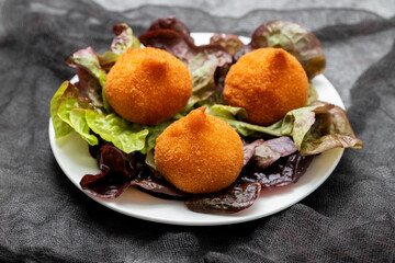 traditional brasilian fried drumsticks Coxinha de frango on dish