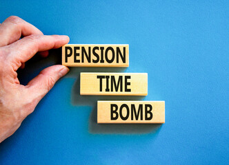 Pension time bomb symbol. Concept words Pension time bomb on wooden blocks on a beautiful blue table blue background. Businessman hand. Business pension time bomb concept. Copy space.