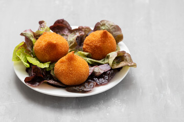 traditional brasilian fried drumsticks Coxinha de frango on dish