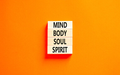 Mind body soul spirit symbol. Concept words Mind Body Soul Spirit on wooden blocks. Beautiful orange table orange background. Lifestyle mind body soul spirit concept. Copy space.