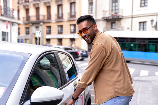 man renting a car through a mobile application. car sharing, car rental by the hour, transportation in the city