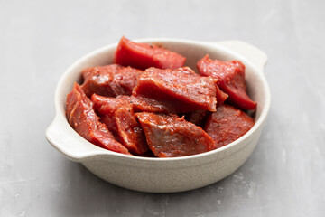 Fresh raw cube of beef in white bowl
