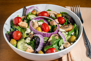 salad top with  chicken  mushrooms and olives