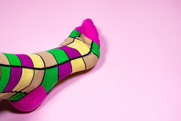 A touch of color on your feet: Socks on a pink background