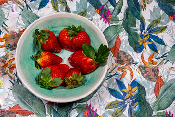 Taste of Paradise: Bowl of Sweet Strawberries on a Tropical Print Table