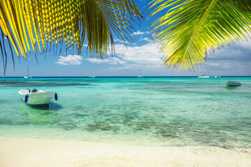 Beautiful caribbean sea and boat on the shore of exotic tropical island, panoramic view from the...