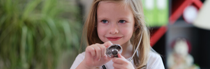 Portrait of beautiful little child girl with stethoscope