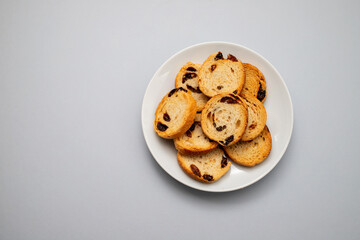 Mini round toasts of bread with raisins on dish