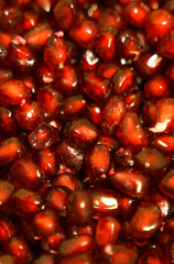 Texture of peeled red pomegranate seeds. Close-up