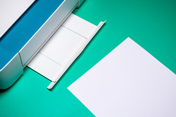 White and Blue Printer with Copy Space on Green Desk: Printing Solution for Your Business