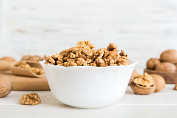 Fresh healthy walnuts in bowl on colored table background. Top view Healthy eating bertholletia concept. Super foods