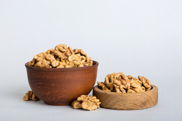 Fresh healthy walnuts in bowl on colored table background. Top view Healthy eating bertholletia concept. Super foods