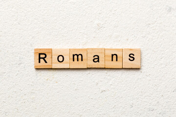 romans word written on wood block. romans text on table, concept