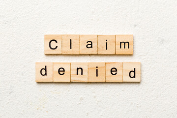 claim denied word written on wood block. claim denied text on table, concept