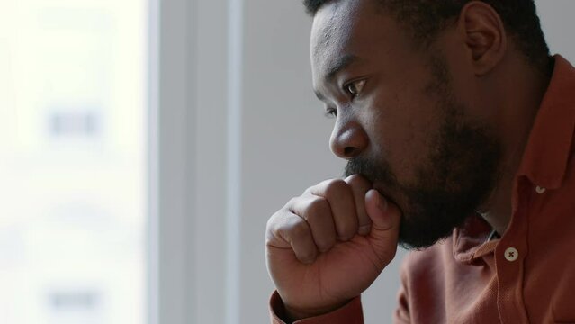 Personal crisis. Young depressed african american man contemplating about life, feeling depressed at home, empty space