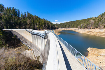 Water dam Hirzmannsperre in Austria with nearly empty water reservoir due to drought