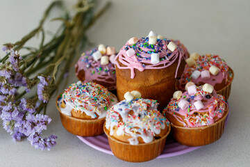 Traditional Ukrainian Easter cake (Paska) with white icing and spring decoration,