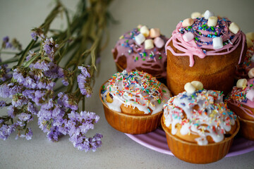 Traditional Ukrainian Easter cake (Paska) with white icing and spring decoration,
