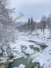 Waterfall on a mountain river. Beautiful winter landscape in the Ukrainian Carpathians.