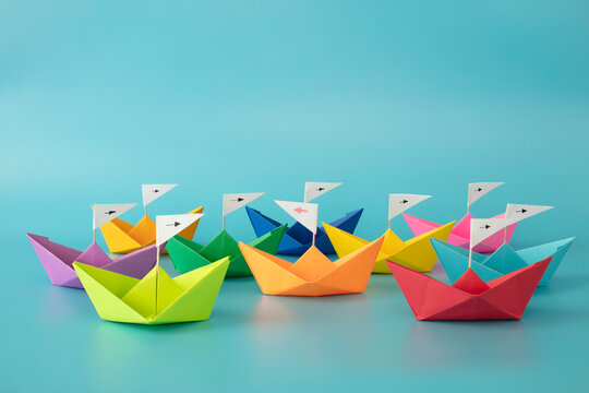 Full color paper ships on blue background. Concept: Make the difference, be yourself, against to the rule, think different, be brave, one in a million, fallow my own destination. 