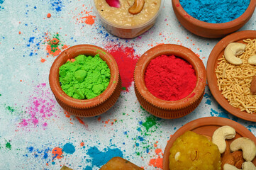 Fototapeta na wymiar top view of colorful traditional holi powder in bowls isolated on dark background.Space for text . happy holi.Concept Indian color festival called Holi