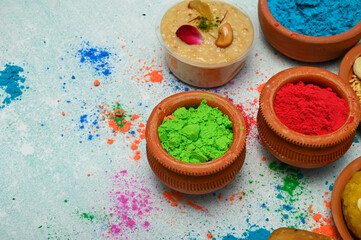 top view of colorful traditional holi powder in bowls isolated on dark background.Space for text . happy holi.Concept Indian color festival called Holi